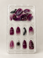 Dark plum ombre press on nails with silver spider and web details in tray