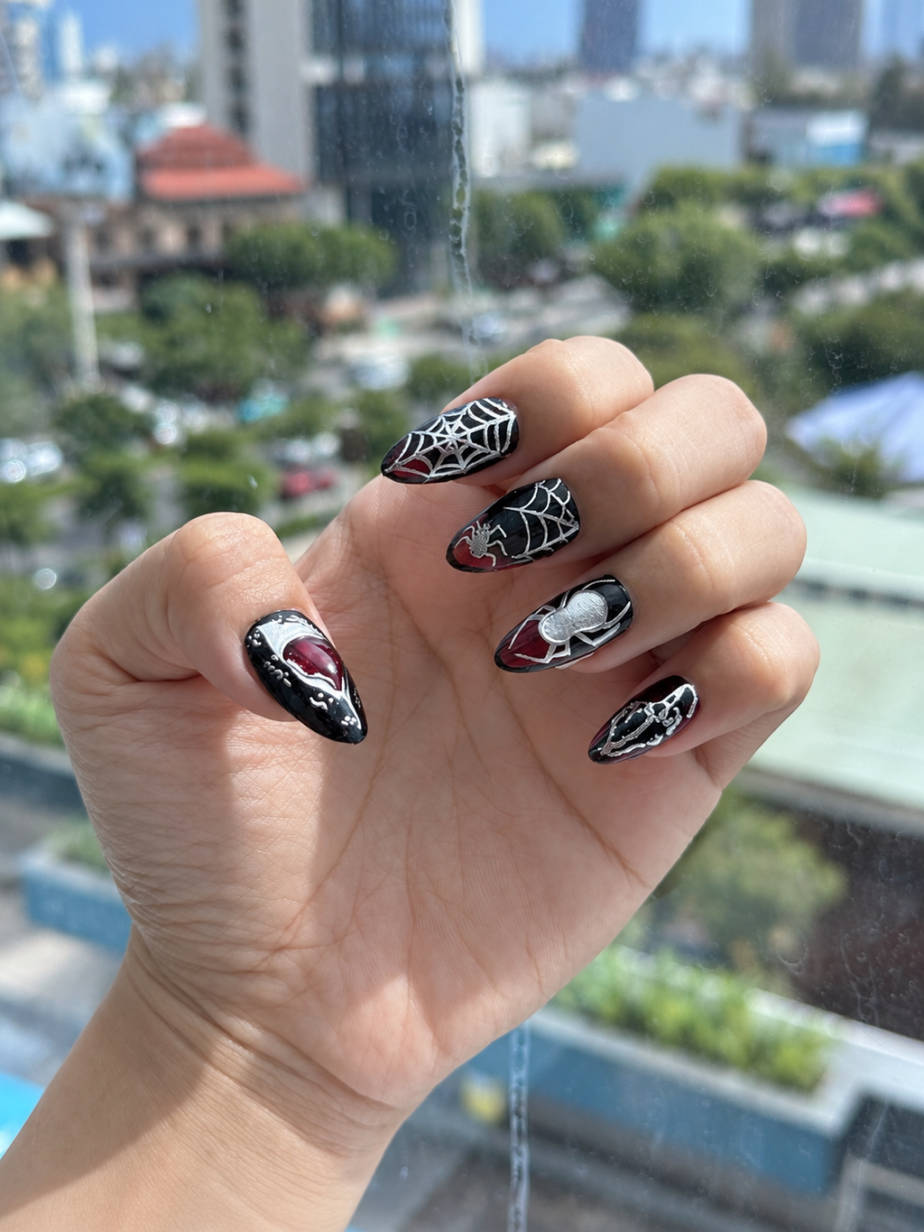 Spiderweb and spider press on nails worn on hand